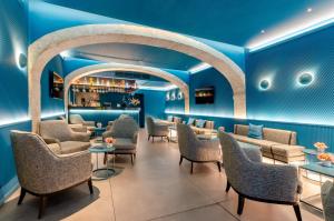 a waiting room with blue walls and chairs at behotelisboa in Lisbon