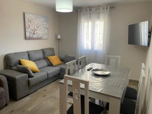 a living room with a couch and a dining room table at El Olivar de la Solana in Castril