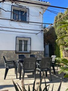 a table and chairs in front of a building at El Olivar de la Solana in Castril