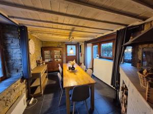a dining room with a table in a tiny house at Le pas de la Fagne in Sprimont