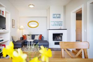a living room with a couch and a fireplace at Brauhaus am See in Gartow