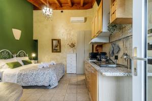 a kitchen with a bed and a sink in a room at Le Dimore Apartments - Garden & Private Parking in Verona