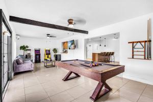 a living room with a pool table in it at Miami Paradise Waterfront Games in North Miami Beach