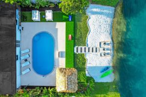 an overhead view of a swimming pool next to the water at Miami Paradise Waterfront Games in North Miami Beach