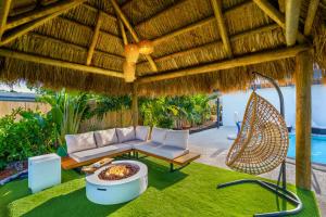 an outdoor patio with a couch and a hammock at Miami Paradise Waterfront Games in North Miami Beach +43 photos