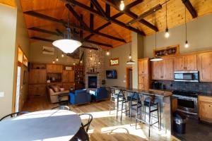 a kitchen with wooden cabinets and a table and chairs at The Train Station in Salina