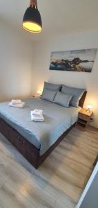 a bedroom with a large bed with two towels on it at PIANISSIMO in Krakow