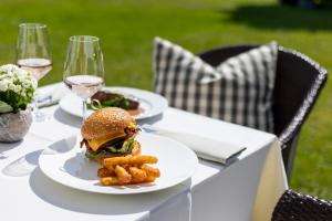 a table with plates of food and glasses of wine at Hotel Adula in Flims +95 photos