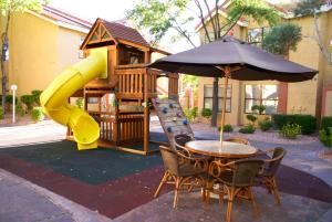 a playground with a table and an umbrella at Westgate Flamingo Bay Resort in Las Vegas