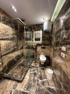 a bathroom with a glass shower and a toilet at New City Plaza in Cairo +120 photos