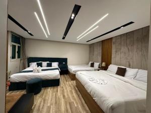 a hotel room with two beds with white sheets at New City Plaza in Cairo