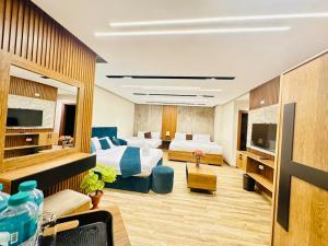 a hotel room with two beds and a television at New City Plaza in Cairo