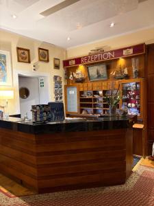 a bar in a restaurant with a counter at Hotel Stolteraa in Warnemünde