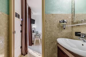 a bathroom with a sink and a mirror at Le Dimore Apartments - Garden & Private Parking in Verona +132 photos