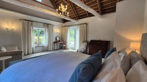 a bedroom with a large bed and a chair at Coppull Private Nature Reserve in Stanford