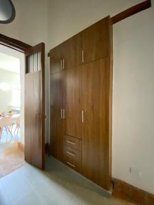 a large wooden cabinet in a room with a door at Apartamento VIP en Buga in Buga +4 photos
