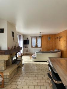 a large living room with a couch and a tub at Chalet les Lurins in Villarlurin