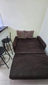 a large brown bed in a room with chairs at Loftt concept in Rio de Janeiro +7 photos