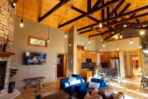 a living room with blue chairs and a fireplace at The Train Station in Salina