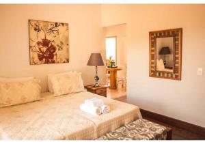 a bedroom with a bed with two towels on it at Lofts do Largo in Tiradentes +6 photos