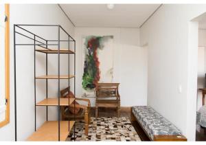 a living room with a couch and a shelf at Lofts do Largo in Tiradentes