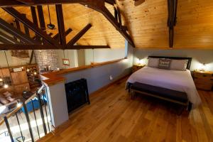 a bedroom with a bed in a room with wooden ceilings at The Train Station in Salina
