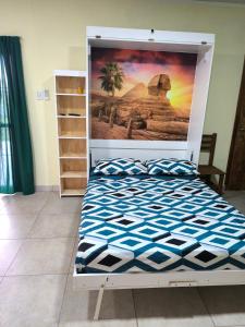 a bed in a room with a poster on the wall at Casa quinta La Ruchi in San Andrés de Giles
