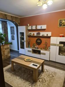 a living room with a table and some shelves at Casa & Julieta in Tecuci