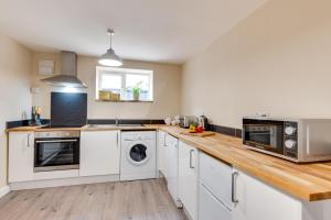 a kitchen with white appliances and a wooden counter top at 2 Bed in Great Waldingfield oc-ac3 in Waldingfield +5 photos