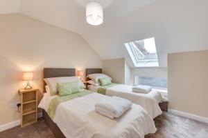 a bedroom with two beds and a window at 2 Bed in Great Waldingfield oc-ac3 in Waldingfield