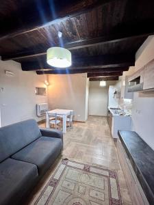 a living room with a couch and a table at Casetta n'da civita in Castrovillari