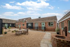 a patio of a house with a table and chairs at 2 Bed in Great Waldingfield oc-ac3 in Waldingfield