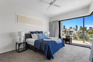 a bedroom with a bed and a large window at Wanderlust heated pool rooftop deck in Gold Coast +80 photos