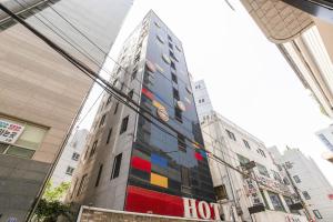 a tall building with a painting on the side of it at Yeongdeungpo Komodo Hotel in Seoul