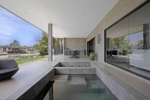 an open living room with a large glass wall at Urban Hideaway - Stay 4 Pay 3 in Gold Coast