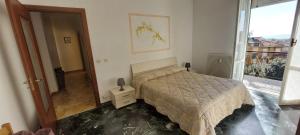 a bedroom with a bed and a large window at Appartamento PANORAMA N 4 POSTI LETTO in Varazze +9 photos