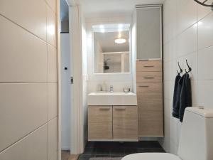 a bathroom with a sink and a toilet at Apartment Norrgården in Genevad