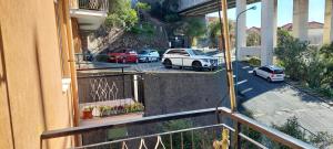 a balcony of a building with cars parked on the street at Appartamento PANORAMA N 4 POSTI LETTO in Varazze