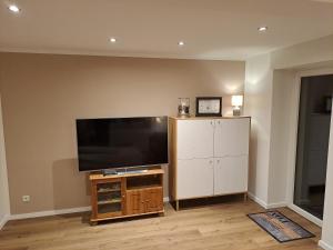 a living room with a flat screen tv on a wall at Ferienhaus Bielefeld in Bielefeld