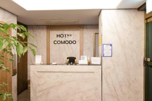 a hotel lobby with a hotel comoda sign on the wall at Yeongdeungpo Komodo Hotel in Seoul