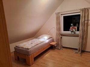 a small room with a bed and a window at Ferienhaus Bielefeld in Bielefeld