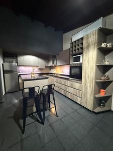 a kitchen with a table and two chairs in it at Casa Ruta 1 in San José