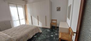 a bedroom with a bed and a desk and a window at Appartamento PANORAMA N 4 POSTI LETTO in Varazze