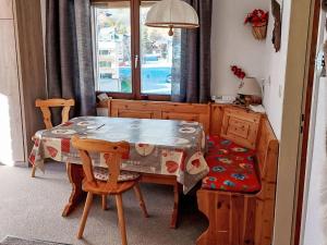 a dining room with a table and a table and chairs at Apartment Orion by Interhome in Leukerbad