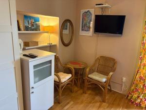 a small room with two chairs and a tv at Apartments Tedeschi in Korčula +24 photos
