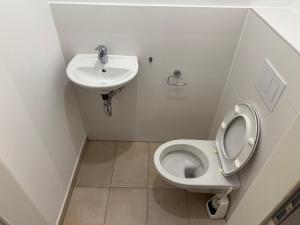 a bathroom with a toilet and a sink at QuietApt Vienna in Vienna