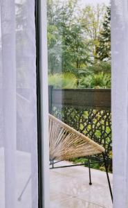 a wicker bench sitting outside a window at Villa Manoca in Boisemont
