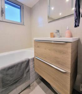 a bathroom with a sink and a bath tub at Villa Manoca in Boisemont