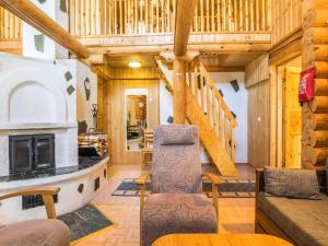 a living room with a staircase and a fireplace at Holiday Home Keisarintupa by Interhome in Ruka