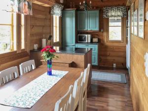 a kitchen with a table with a vase of flowers on it at Holiday Home Joutsen a by Interhome in Ruka